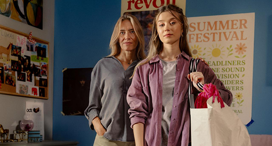 Äiti ja tytär poseeraa yhdessä kauppakassi olalla